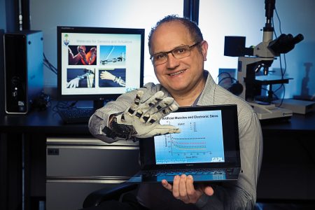Professor Hani Naguib demonstrates a prototype of his smart textile sensing glove based on electro-active polymers | Photo: Rob Waymen